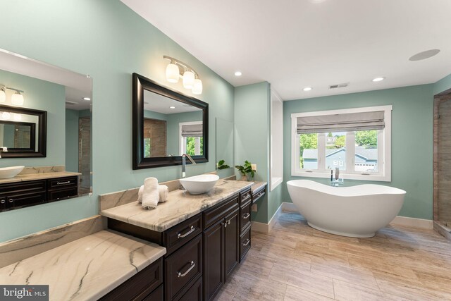 36976 Walnut Park Ln, Purcellville, VA 20132 - bathroom with a soaking tub, vanity, recessed lighting, and baseboards