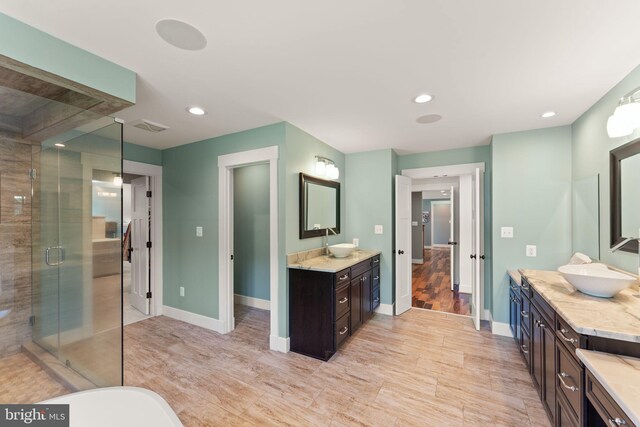 36976 Walnut Park Ln, Purcellville, VA 20132 - bathroom featuring two vanities, a shower stall, baseboards, recessed lighting, and wood finished floors