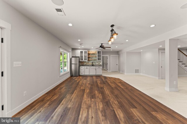 36976 Walnut Park Ln, Purcellville, VA 20132 - unfurnished living room featuring stairway, a ceiling fan, recessed lighting, baseboards, and a sink