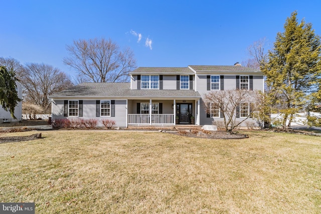 view of front of property with a front yard and covered porch