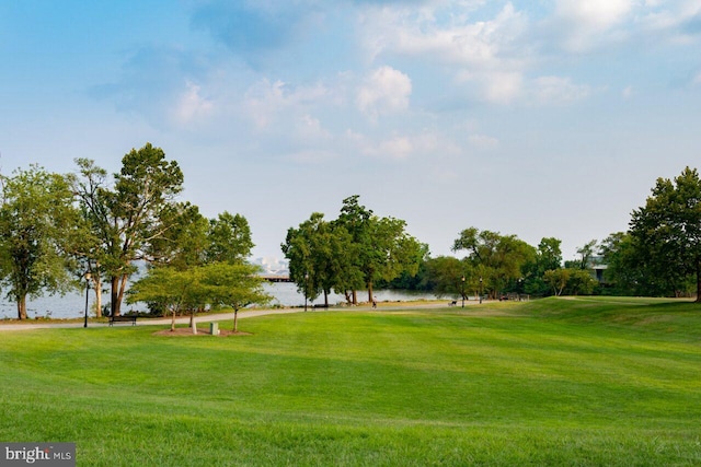 view of property's community with a water view and a yard