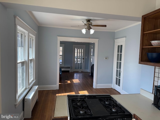 foyer featuring baseboards, radiator, ceiling fan, ornamental molding, and dark wood-style flooring