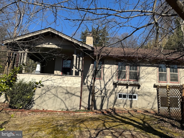 view of home's exterior with a yard and a chimney