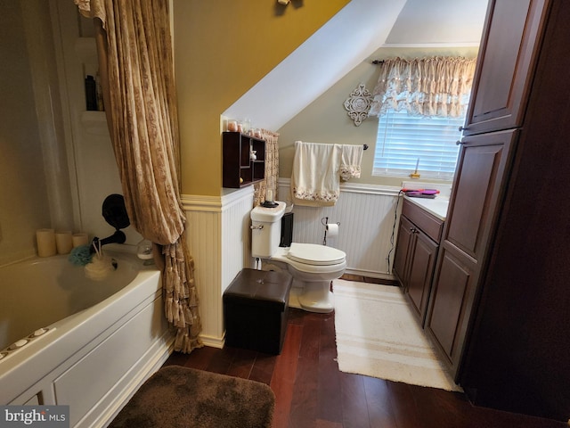 bathroom featuring toilet, wood finished floors, and wainscoting