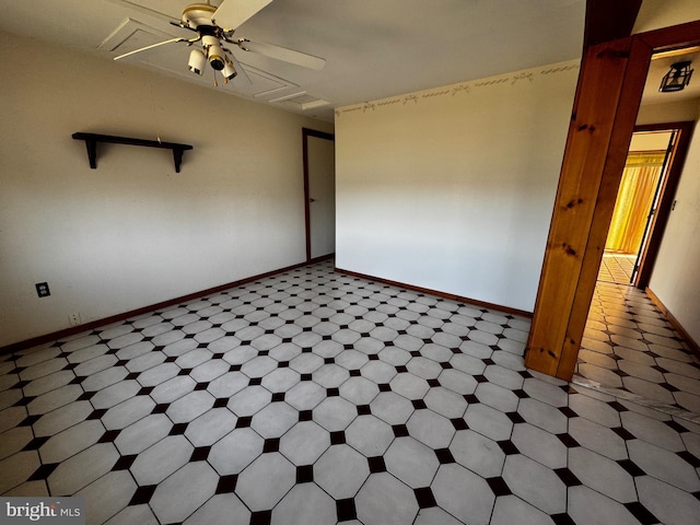 unfurnished room featuring tile patterned floors, baseboards, and a ceiling fan