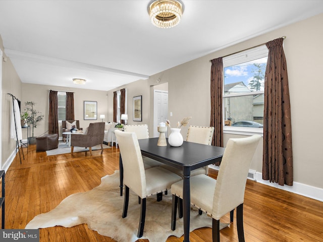 dining area featuring light wood finished floors and baseboards