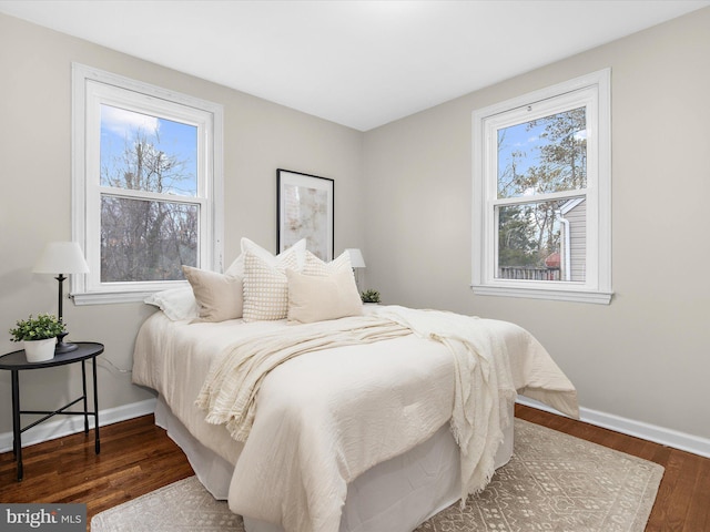 bedroom featuring baseboards and wood finished floors