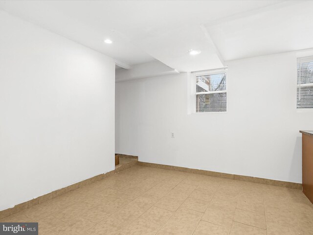 basement with plenty of natural light, baseboards, and recessed lighting