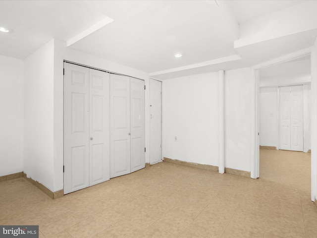 unfurnished bedroom with a closet and baseboards