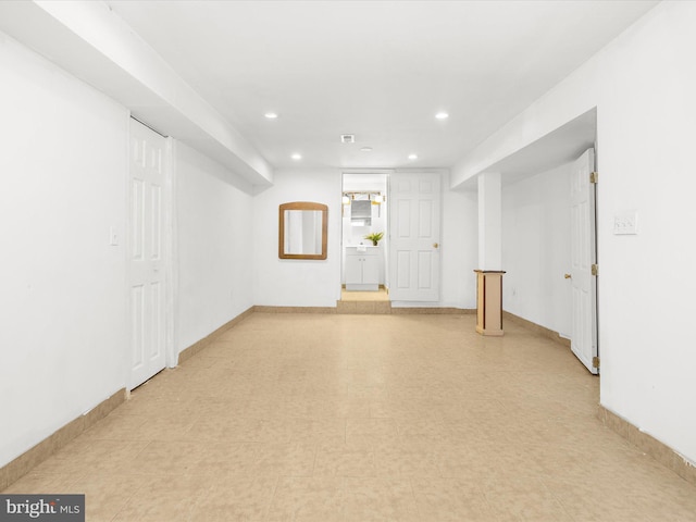 unfurnished room featuring baseboards and recessed lighting