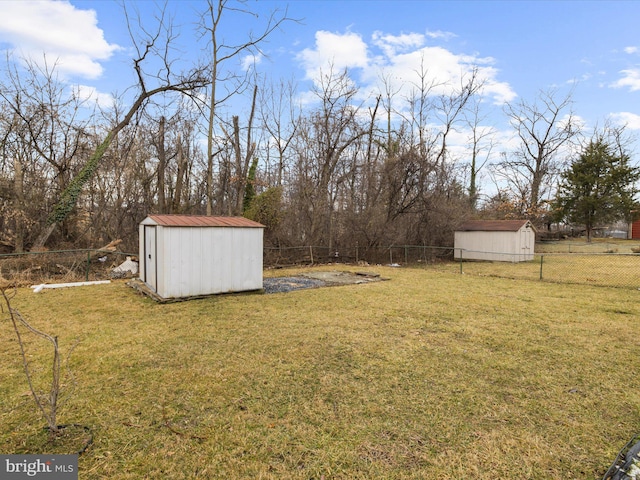 view of yard featuring a fenced backyard, a storage unit, and an outdoor structure