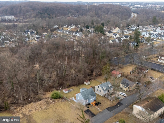 birds eye view of property with a wooded view and a residential view