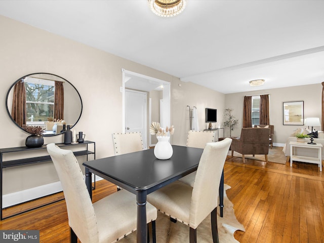 dining room with hardwood / wood-style floors and baseboards