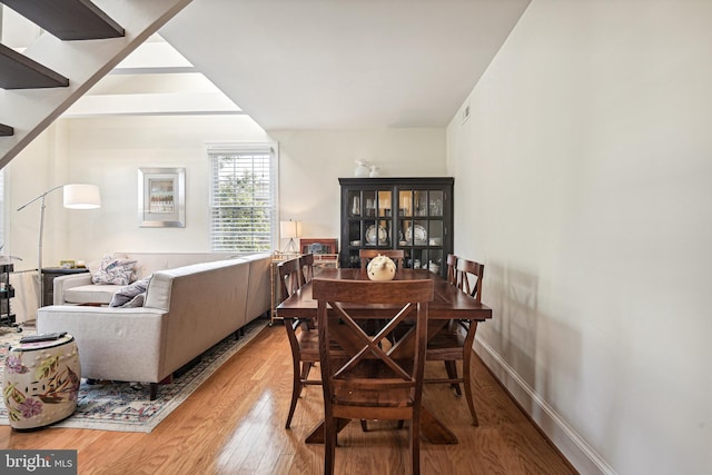 dining room featuring baseboards and hardwood / wood-style floors