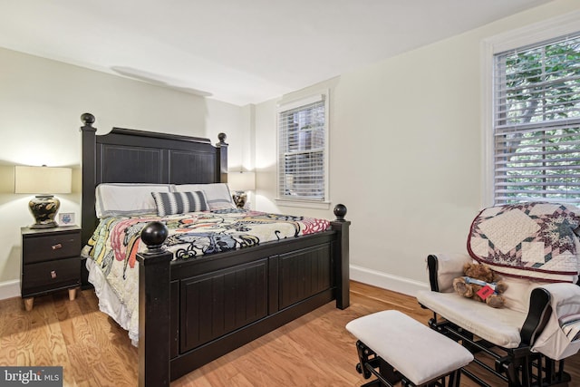 bedroom featuring baseboards and light wood-style floors