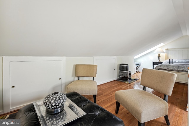 bedroom with lofted ceiling and wood finished floors