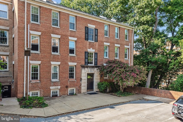 view of property featuring uncovered parking