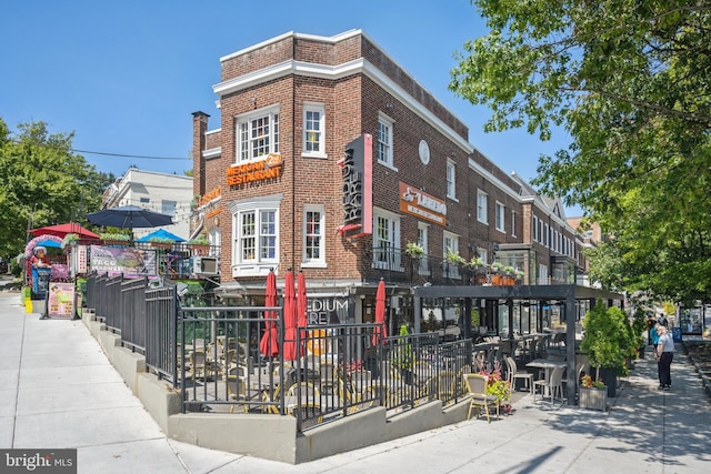 view of building exterior with fence