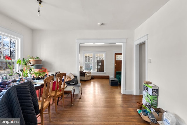 dining room with baseboards and dark wood finished floors