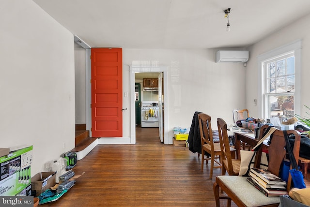 dining area with an AC wall unit and dark wood-style flooring