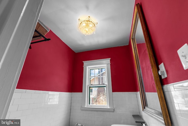 bonus room with a chandelier and wainscoting