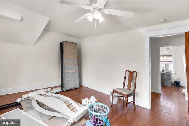 sitting room with ceiling fan, baseboards, and dark wood finished floors