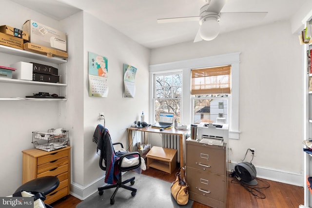 office area featuring wood finished floors, a ceiling fan, and baseboards