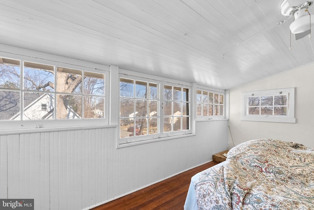 bedroom featuring dark wood-type flooring, lofted ceiling, wooden ceiling, and multiple windows