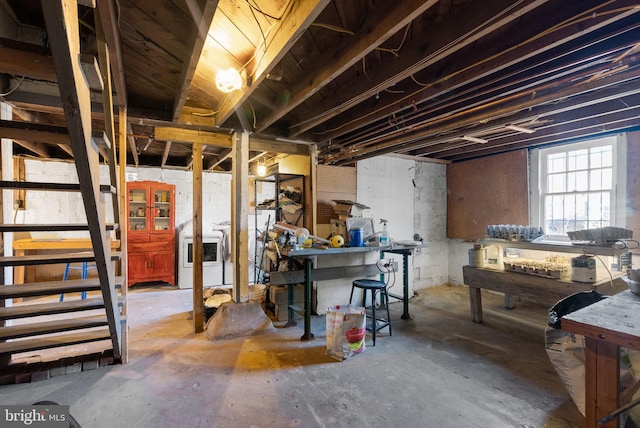 basement featuring independent washer and dryer and a workshop area