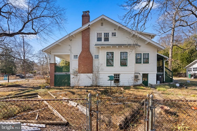 view of home's exterior with fence private yard, a gate, a garden, and a chimney