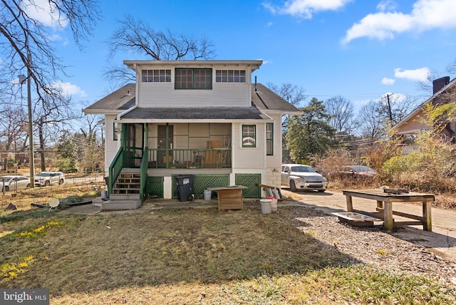 back of house featuring stairs and a sunroom