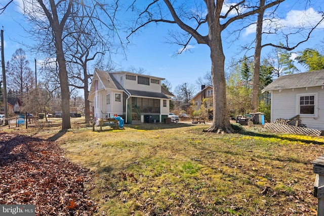 view of yard with a sunroom and fence