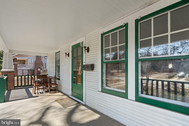 wooden terrace featuring covered porch