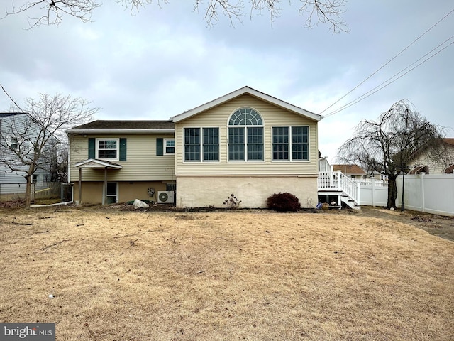 exterior space featuring a yard, fence, and central air condition unit