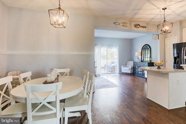 dining room featuring a chandelier and dark wood-style flooring