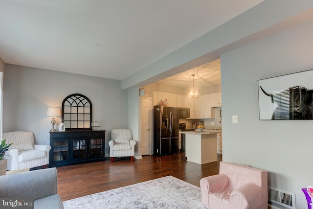 living room with baseboards, visible vents, and dark wood finished floors