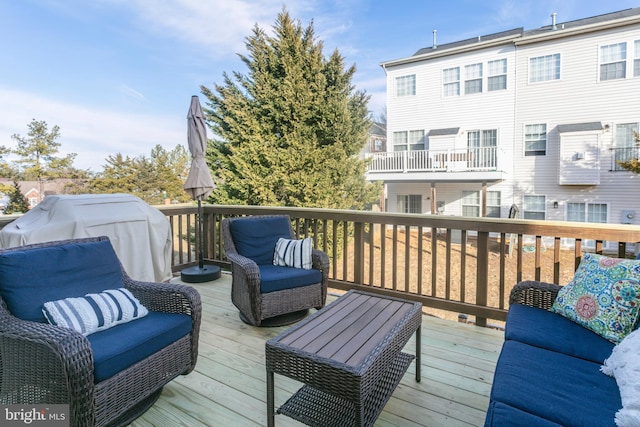 wooden terrace featuring outdoor lounge area