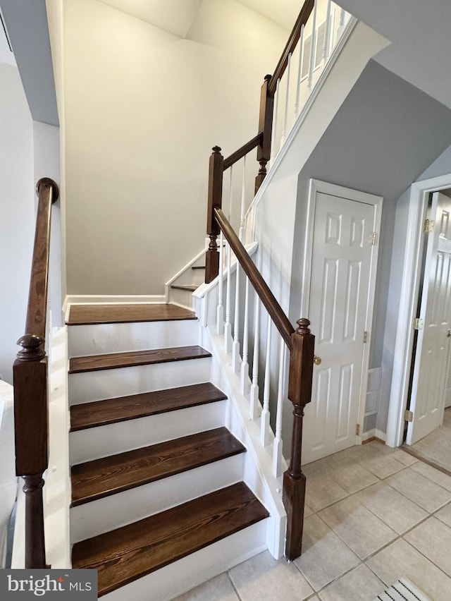 stairs featuring tile patterned flooring