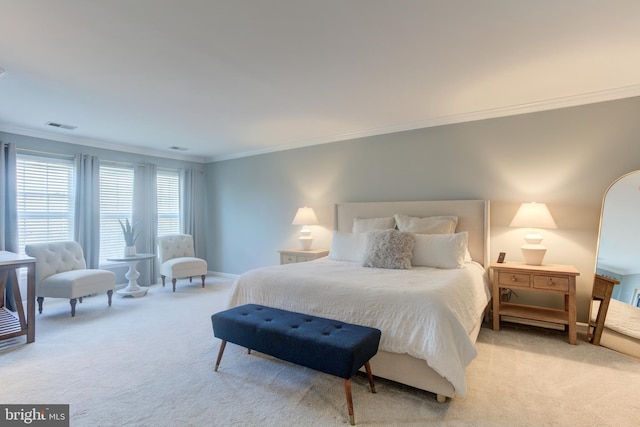 bedroom featuring crown molding, baseboards, visible vents, and light colored carpet