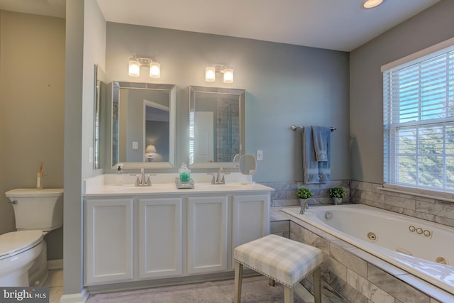 full bath with a jetted tub, plenty of natural light, and a sink