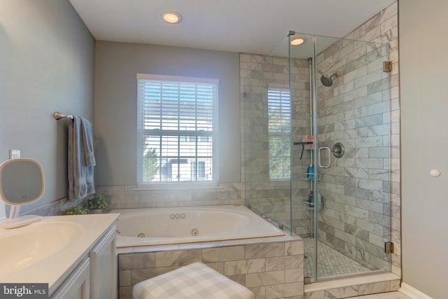 full bathroom with a shower stall, a tub with jets, and vanity