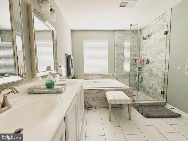 full bathroom with a bath, a shower stall, visible vents, and a sink