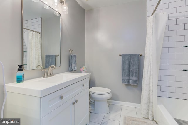 bathroom with marble finish floor, vanity, toilet, and baseboards