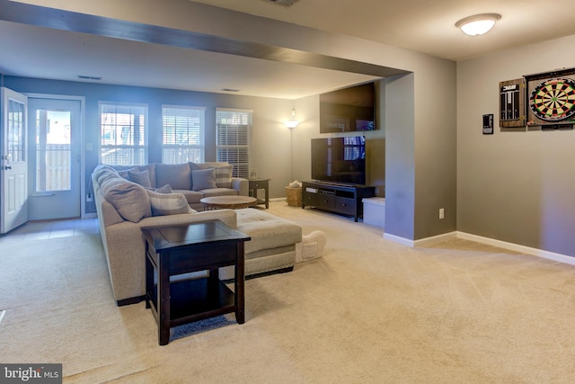 carpeted living room with visible vents and baseboards