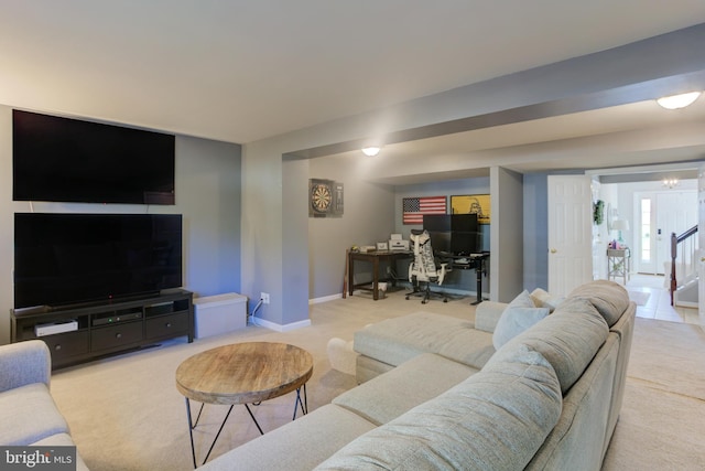 carpeted living room featuring stairs and baseboards