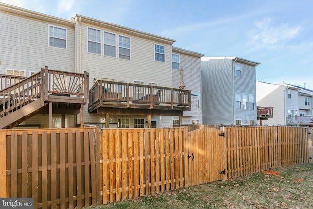 back of property featuring fence private yard and a gate