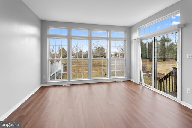 unfurnished sunroom featuring visible vents