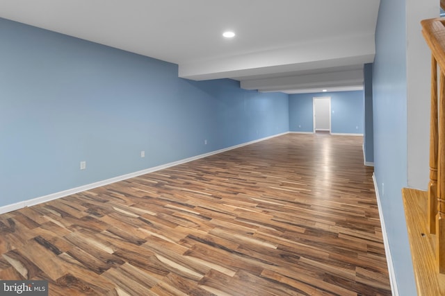 spare room with baseboards, dark wood-style flooring, and recessed lighting