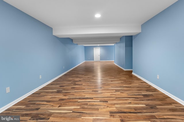 spare room featuring baseboards, wood finished floors, and recessed lighting