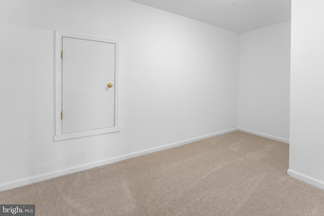 unfurnished room featuring carpet flooring and baseboards